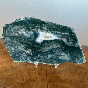 Beautiful green Moss Agate slab on a clear stand
